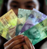 Bali VAT and Sales Tax- Guide - Girl Holding Rupiah | BaliKit